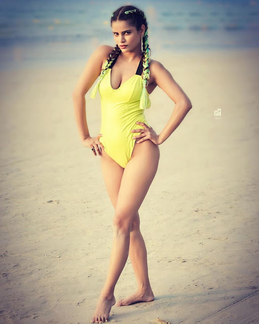 Archana Gautam posing in a swimsuit with a bold expression.