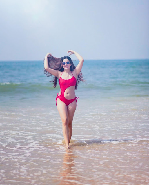 Aditi Budhathoki wearing a bikini, posing confidently by the beach.