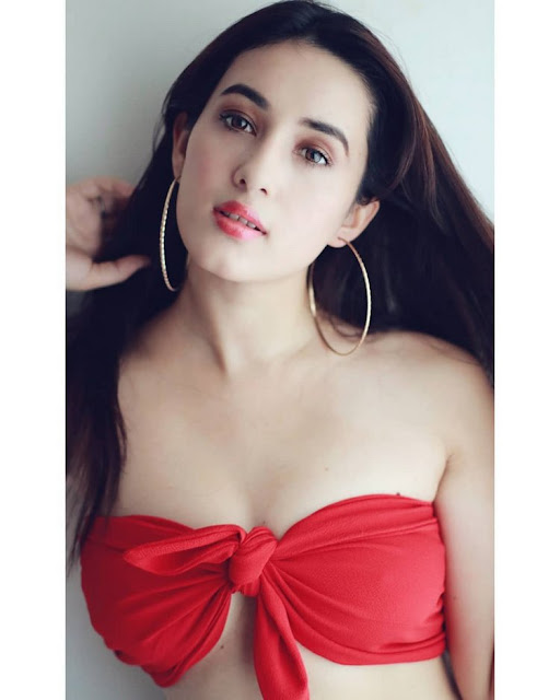Aditi Budhathoki wearing a bikini, posing confidently by the beach.