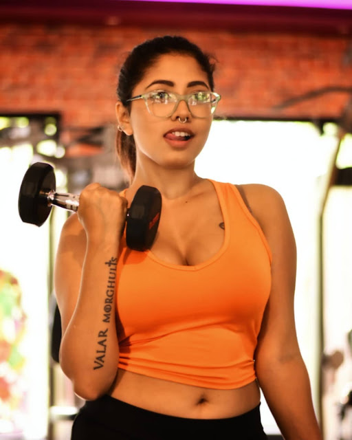 Yajnaseni striking a confident pose in stylish gym wear.