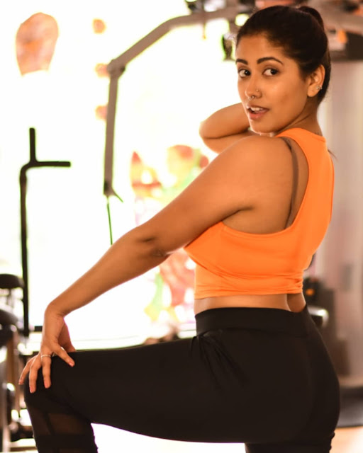 Yajnaseni striking a confident pose in stylish gym wear.