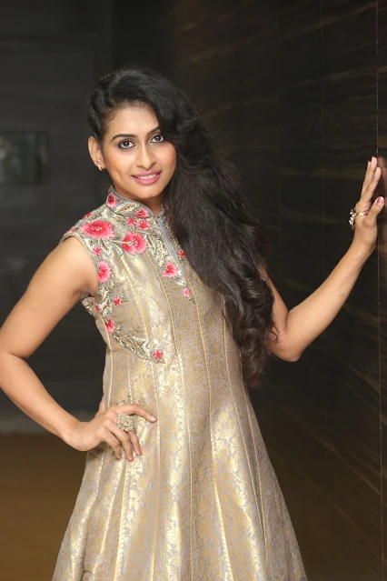 Nitya Naresh posing in sleeveless long dress, smiling