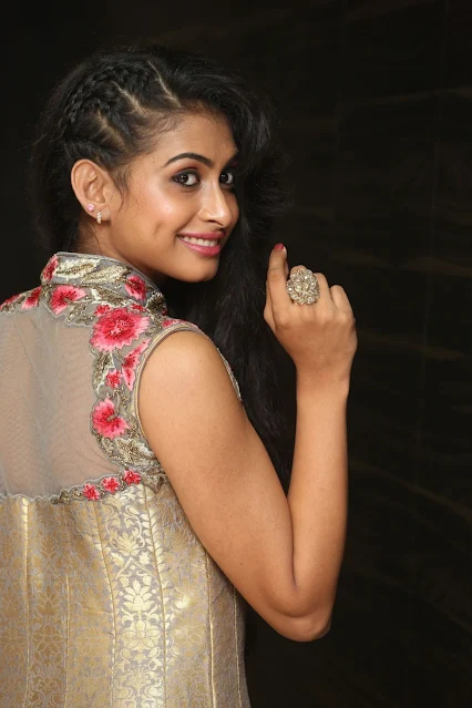 Nitya Naresh posing in sleeveless long dress, smiling