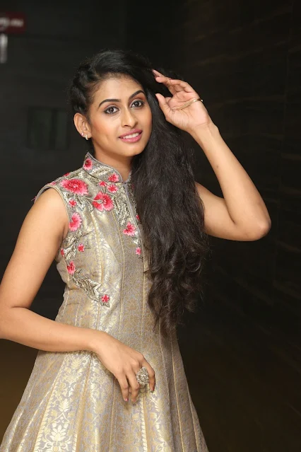 Nitya Naresh posing in sleeveless long dress, smiling