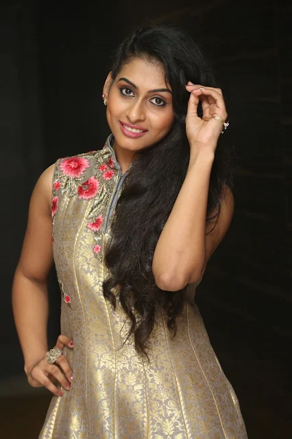 Nitya Naresh posing in sleeveless long dress, smiling