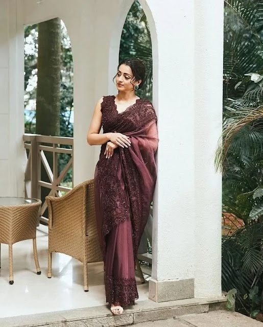 Trisha Krishnan smiling in elegant maroon saree