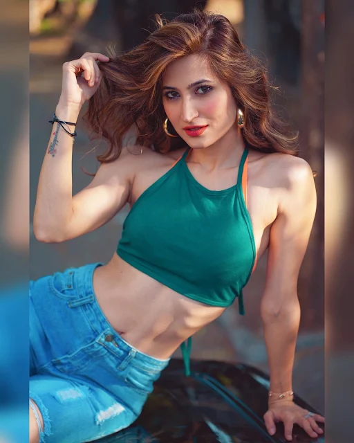 Noorin Sha in green halter crop top and jeans