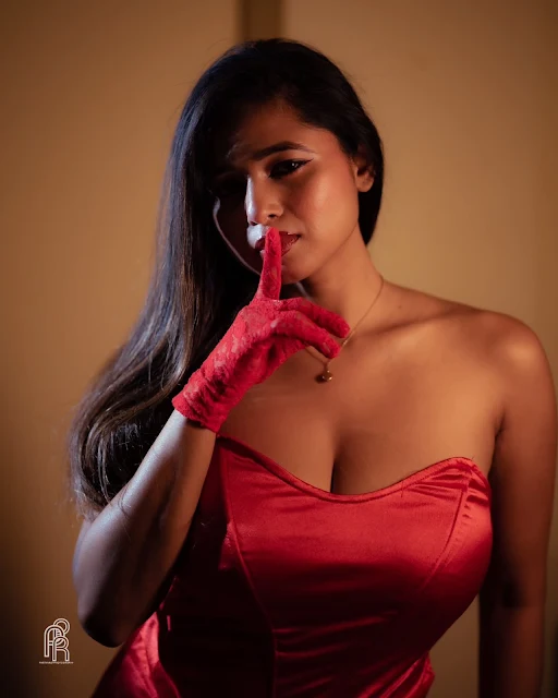Shipra Tarafder wearing a fitted strapless red satin dress
