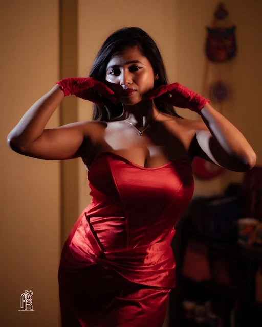 Shipra Tarafder wearing a fitted strapless red satin dress