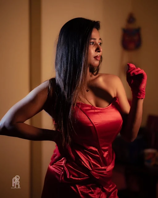 Shipra Tarafder wearing a fitted strapless red satin dress