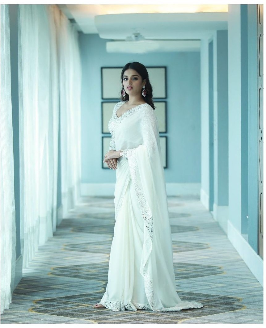 Nidhhi Agerwal looks regal in an ivory mirror work saree and blouse! Celebrity Sarees