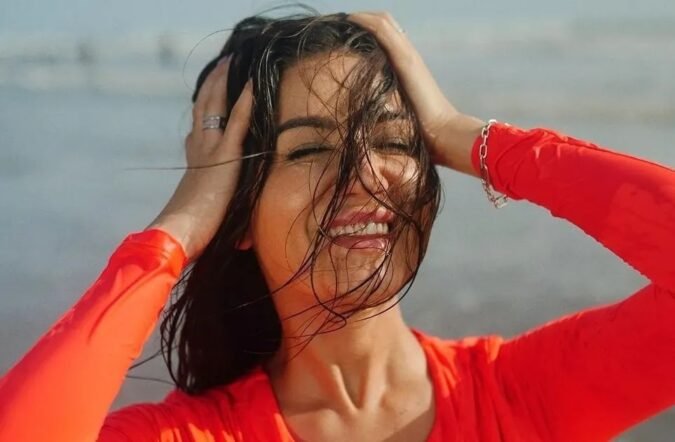 Amy Aela Looks Vibrant in Neon Orange Resort Wear Celebrity Sarees